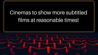 Movie theatre black screen with red chairs in rows facing it. Text on screen says 'cinemas to show more subtitled films at reasonable times'