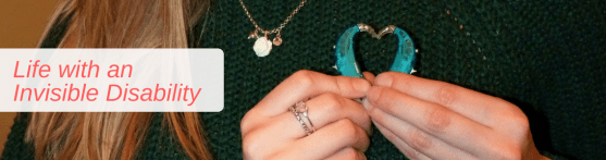 Image banner of a close up holding my hearing aids in a heart shape near my heart and text to the left saying 'Life with an Invisible Disability'