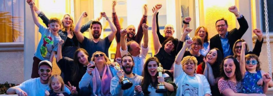 A group photo of The Silent Child Team with their Oscar trophies cheering