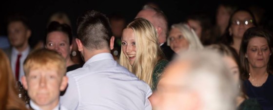 My surprised look after I went to collect my award talking to my boyfriend to my left, all the other faces are blurred into the background.