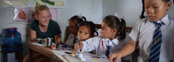 Me watching over young students in a painting class